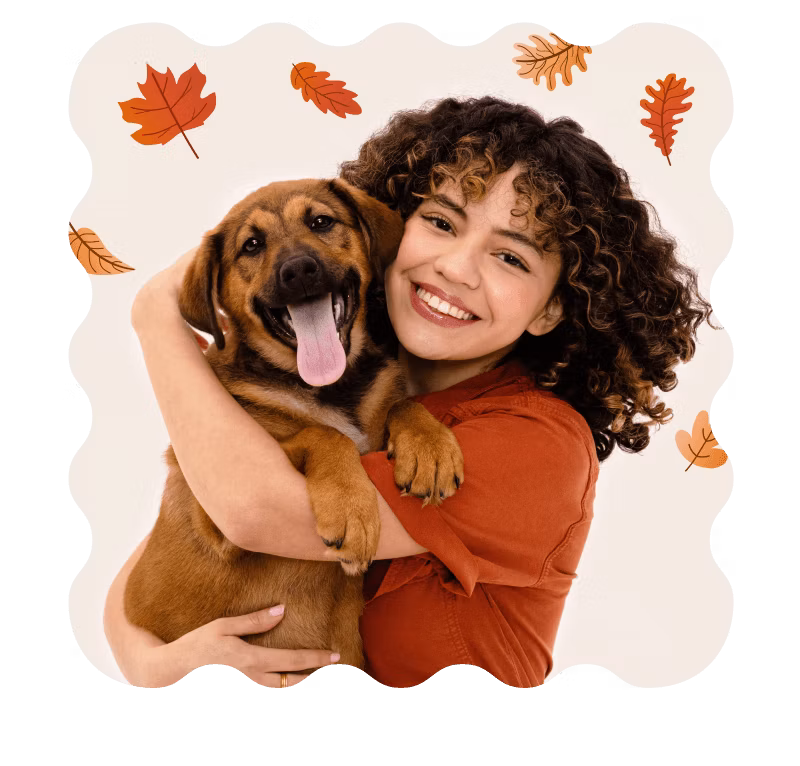 Happy dog and pet parent with autumn leaves