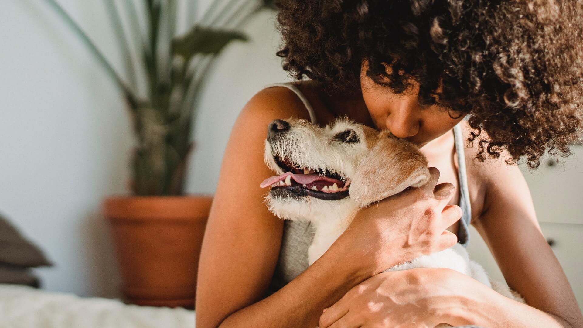 Woman hugging dog for emotional support