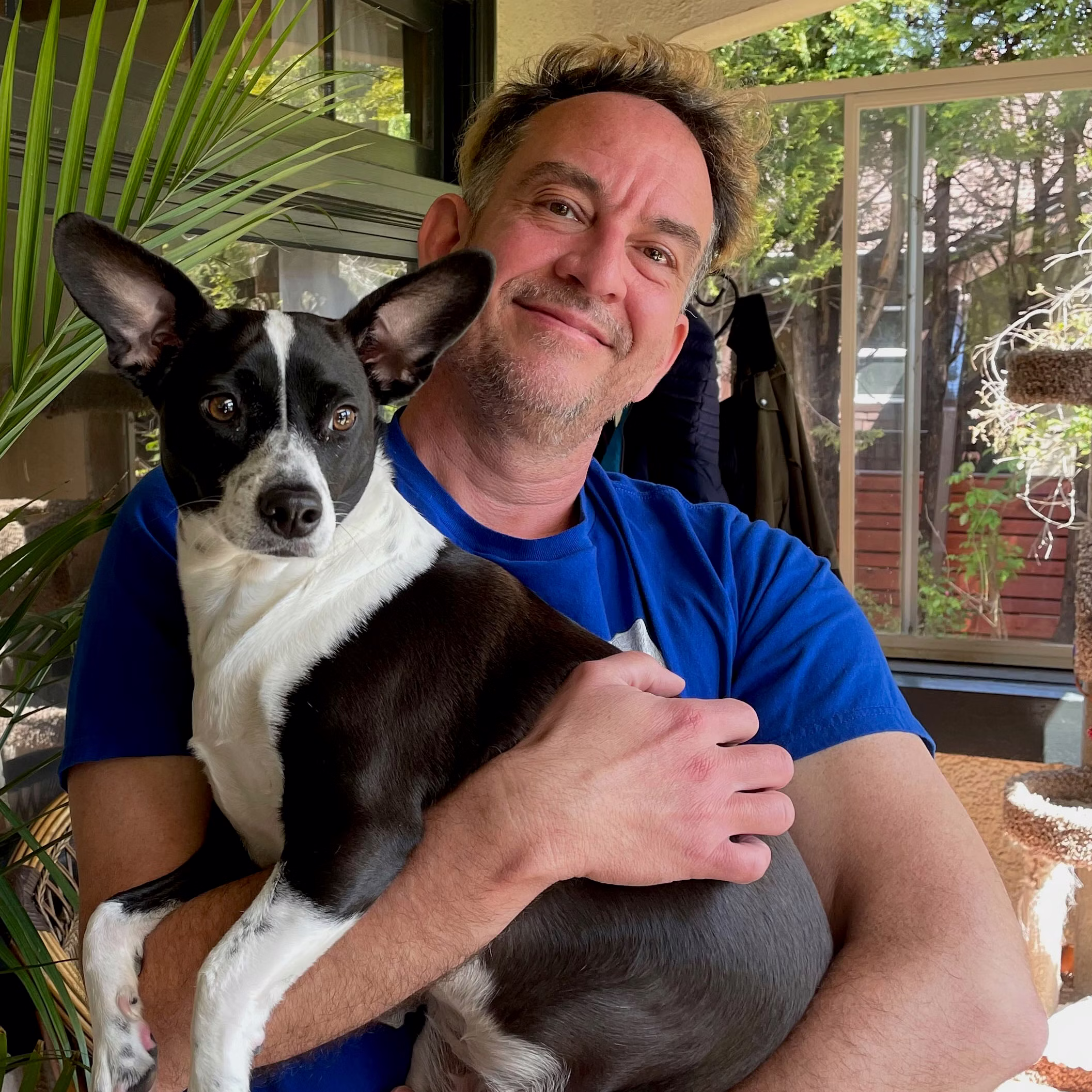  Dan Garrigan holds a cute black and white dog